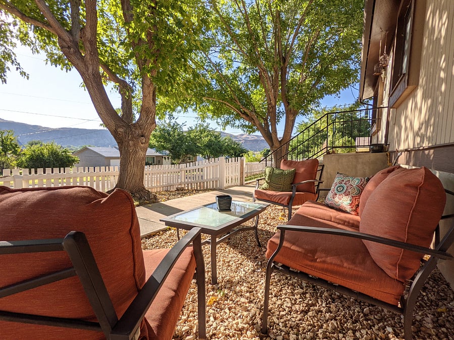 Exterior seating area underneath large shade trees; perfect for morning coffee as the sun rises over the mountains. 
