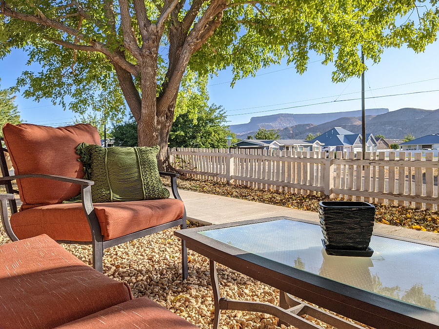 Exterior seating area underneath large shade trees; perfect for morning coffee as the sun rises over the mountains. 