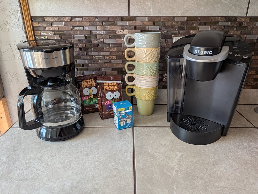 Multiple coffee makers, including drip, Keurig, cold brew container, french press, percolator. Electric and stovetop tea kettles. 
