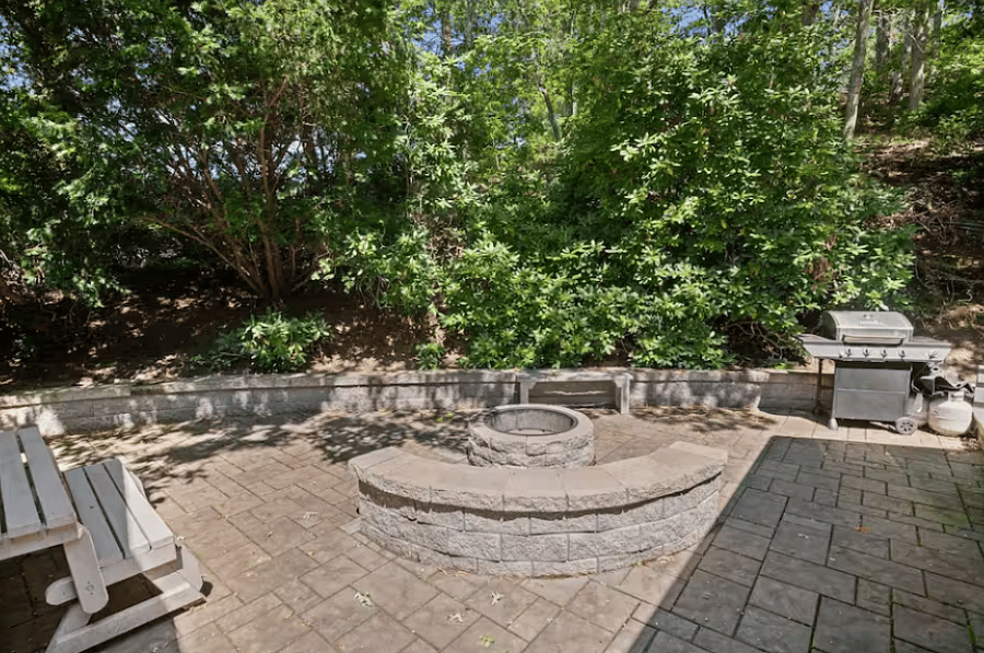 The private outdoor fire pit offers a warm and inviting space to unwind under the Cape Cod sky. Perfect for quiet evenings or gathering with friends, it adds a cozy, relaxed ambiance to the homes outdoor setting.