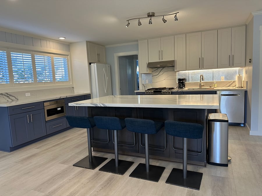 Brand new modern kitchen with oversized island for food prep and dining.