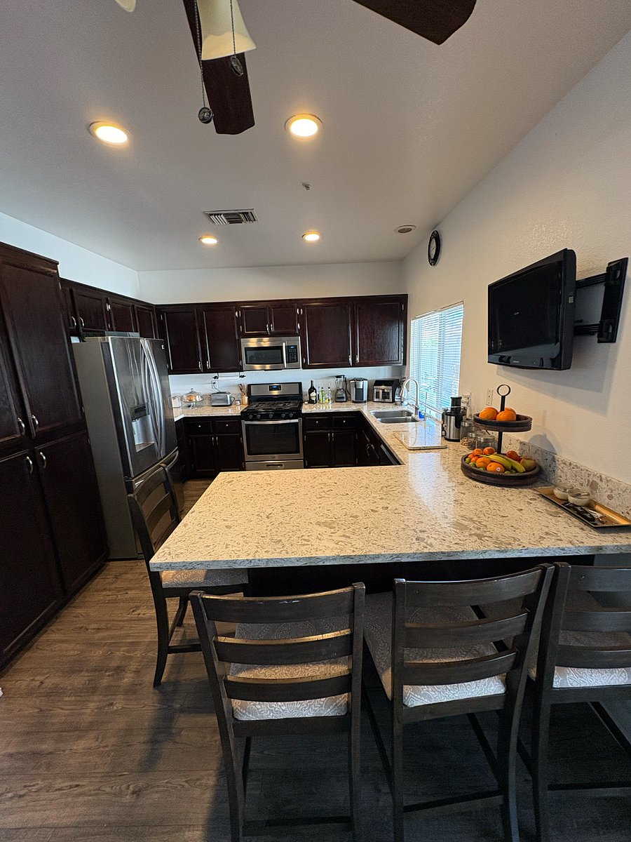Kitchen with island, microwave and big fridge