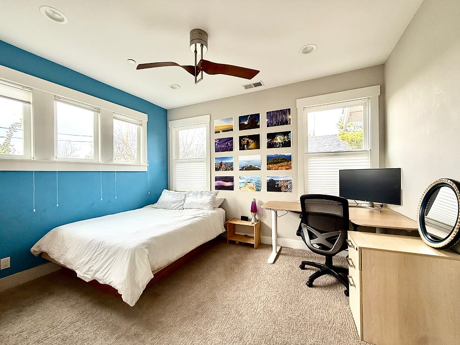 Upstairs bedroom with queen bed and built in desk. 