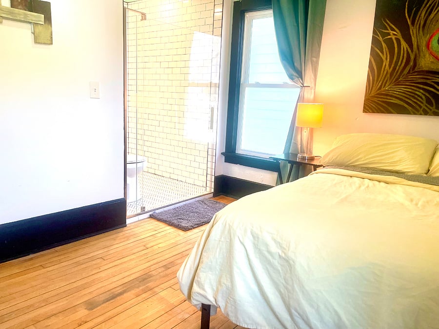 Bedroom 2: Full size bed, TV, microwave, mini-fridge, and attached bathroom
