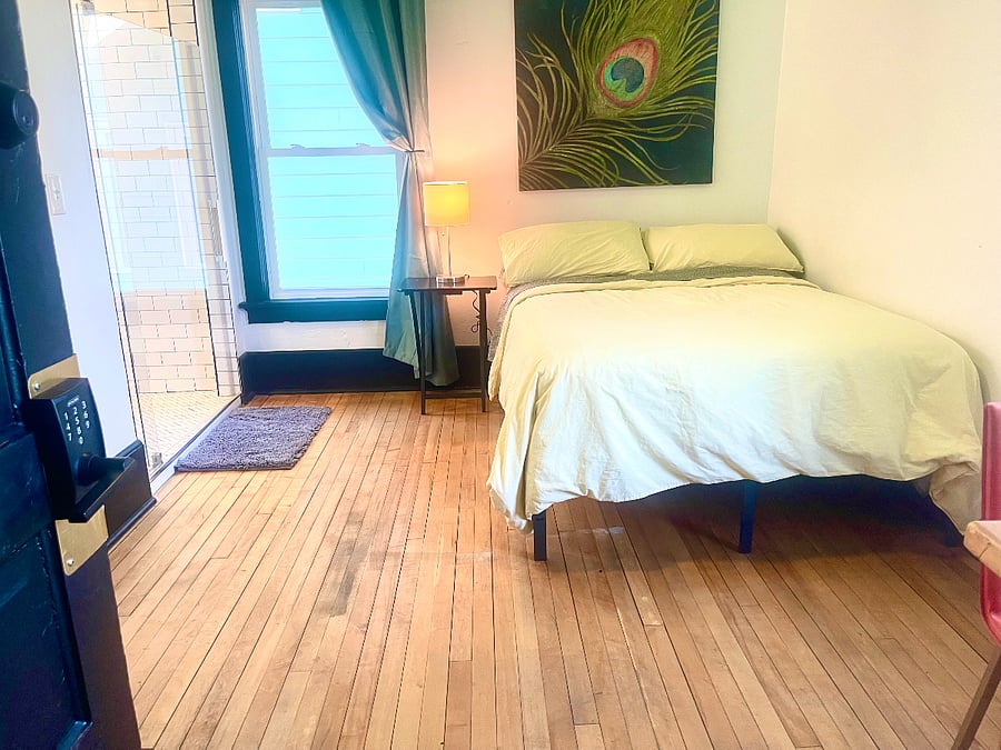 Bedroom 2: Full size bed, TV, microwave, mini-fridge, and attached bathroom