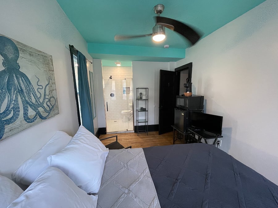 Bedroom 5: Full size bed, TV, microwave, mini-fridge, single-serve coffee maker and attached bathroom