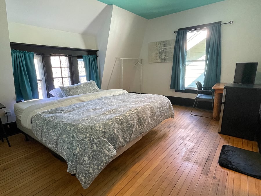 Bedroom 3: King size bed, TV, mini-fridge, microwave, and attached bathroom
