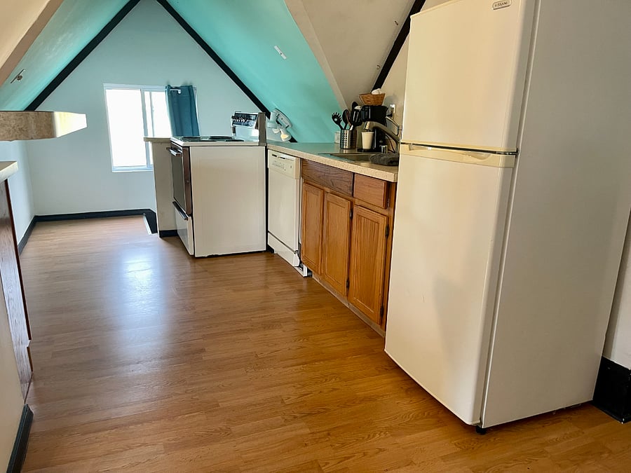 Bedroom 1 / The in-law suite located on the 3rd floor of the home. Queen- size bed, sofa, full kitchen, TV, mini-fridge, microwave, attached bathroom