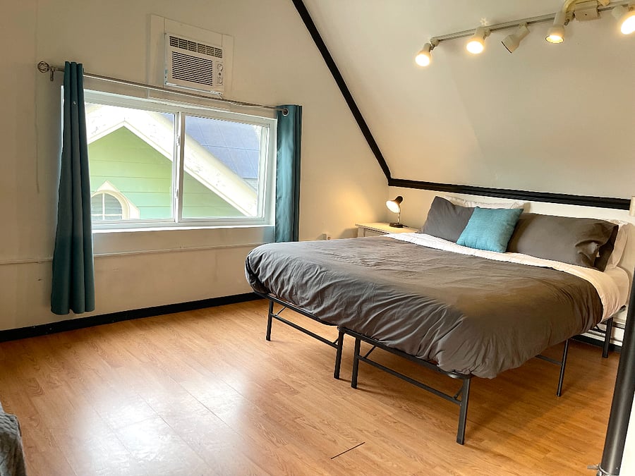 Bedroom 1 / The in-law suite located on the 3rd floor of the home. Queen- size bed, sofa, full kitchen, TV, mini-fridge, microwave, attached bathroom