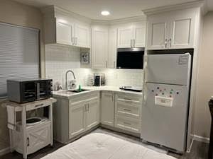 New microwave over range hood, hot plate, Keurig coffee maker, convection oven and fully equipped utensils, and cookware.
