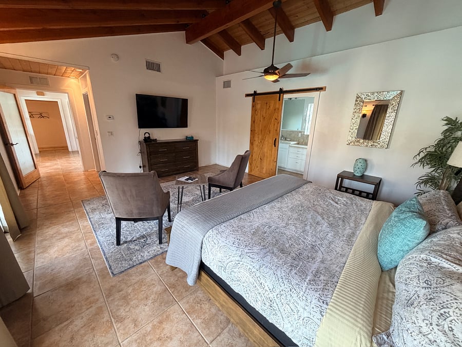 Spacious and serene with a king bed, vaulted ceilings, tv, and pool access.