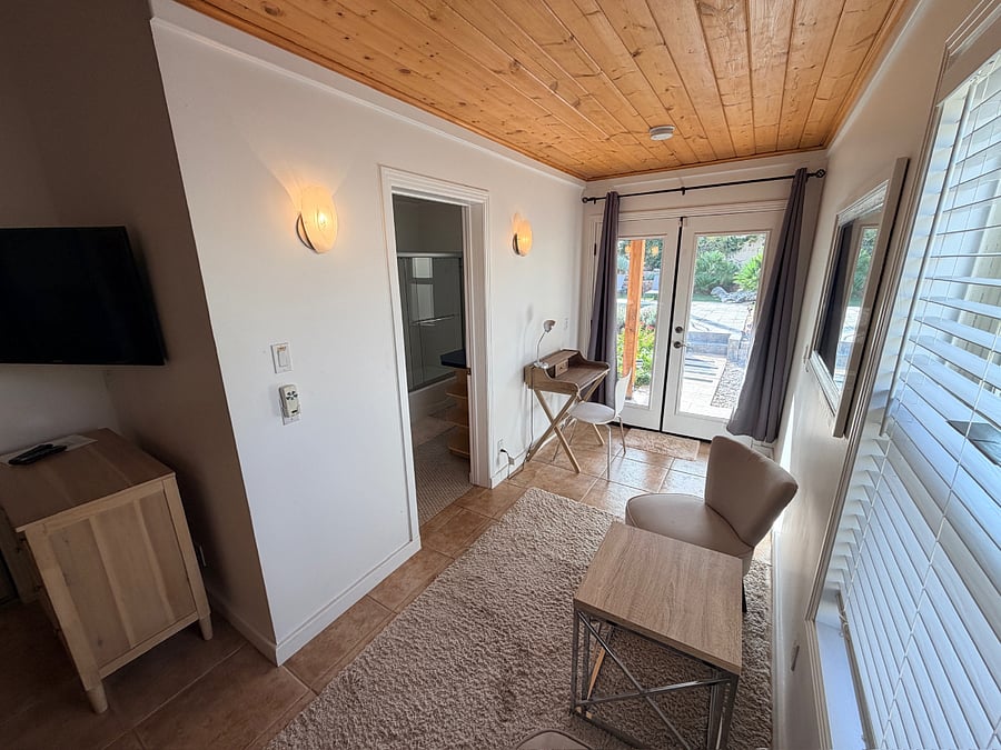 Featuring a queen bed, full en-suite bath, and easy walkout access to the pool for seamless indoor-outdoor living.