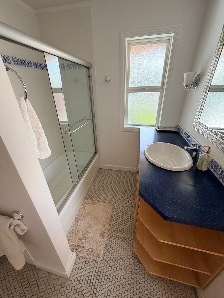 Featuring a queen bed, full en-suite bath, and easy walkout access to the pool for seamless indoor-outdoor living.