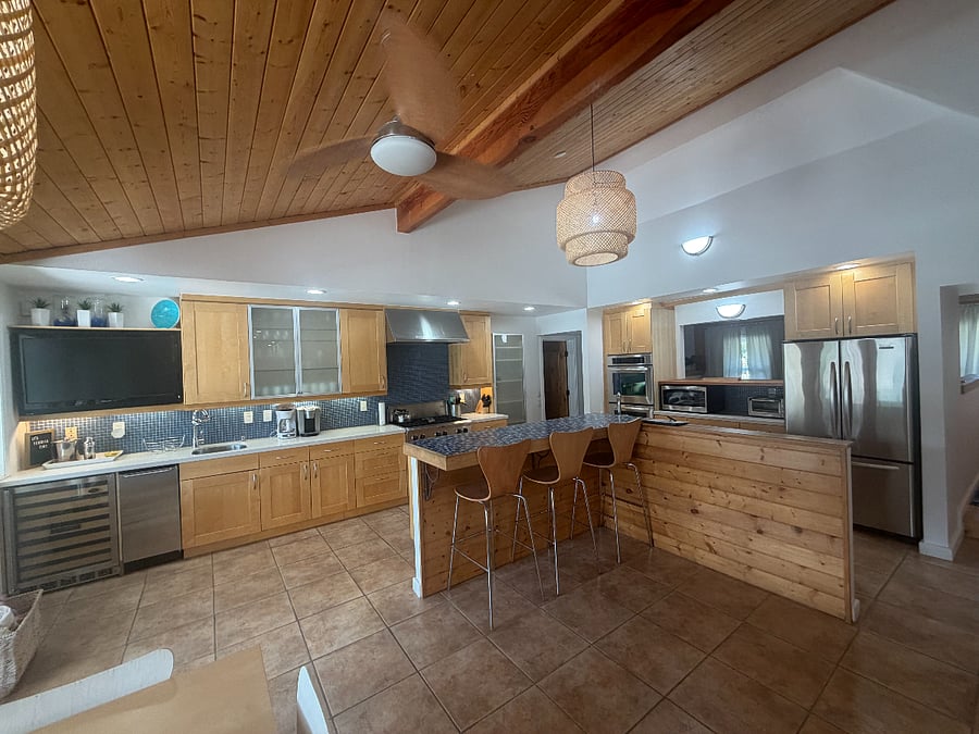 Spacious, fully equipped kitchen stocked with essentials, featuring both large and small appliances.