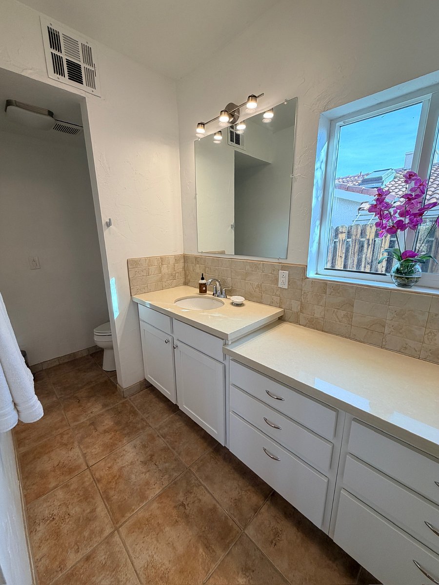Primary in-suite full bathroom featuring double sinks and a spa-like shower.