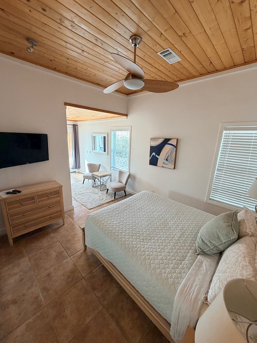 Featuring a queen bed, full en-suite bath, and easy walkout access to the pool for seamless indoor-outdoor living.
