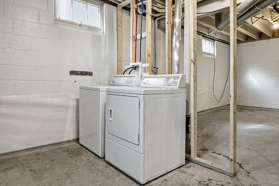 Speed Queen washer and dryer in the unfinished but clean basement
