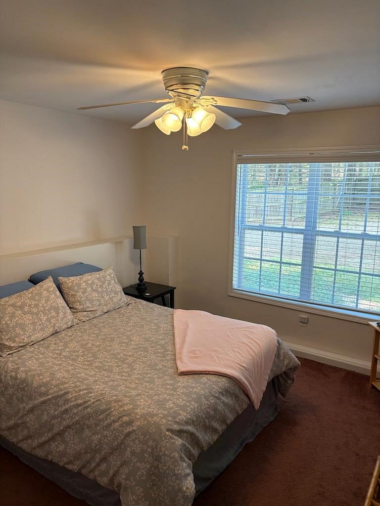 Bedroom 1 with window looking out at backyard