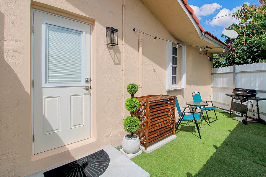 Private patio with barbecue and seats and table