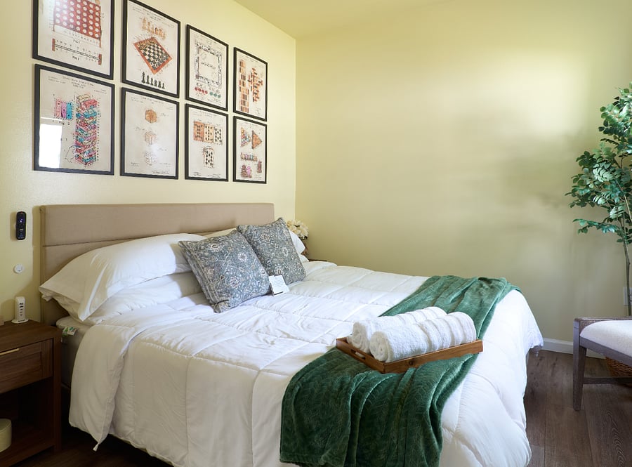 Rest easy in the king bedroom with fresh linens and soft green accents