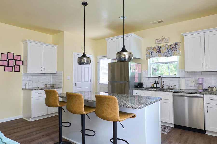 Enjoy a bright kitchen with island seating and easy backyard access
