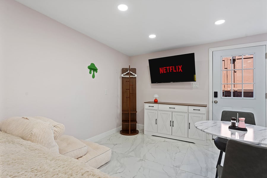 Bedroom with TV for entertainment.
