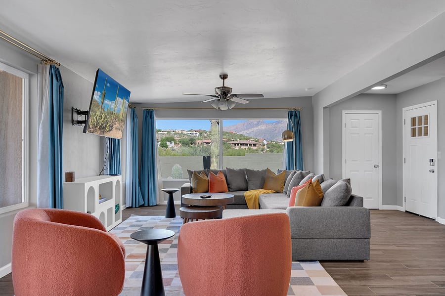 Kick back in a cozy living space featuring a soft sofa, streaming TV, and charming dcor. The rooms warm lighting and welcoming vibe make it ideal for relaxing after a busy day of adventure.