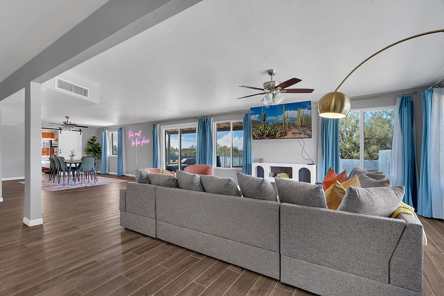 Unwind in a bright, modern living room with a plush sofa, smart TV, and stylish dcor. Natural light fills the space, creating a warm, relaxing atmosphereperfect for movie nights or quiet evenings in.