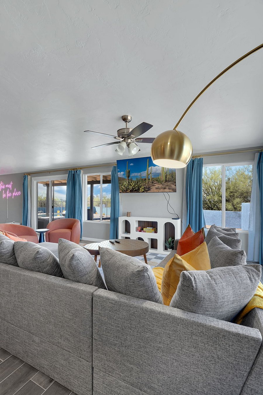 Relax in a light-filled living area with a comfy sofa, smart TV, and minimalist dcor. The open layout and calm atmosphere make it a great spot to recharge after a day out exploring.