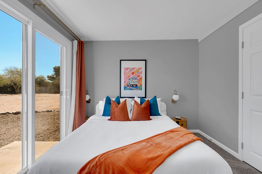 Wake up to natural light in this bright bedroom with crisp bedding, warm dcor, and a flat-screen TV. Ideal for unwinding with a movie after a busy day exploring the area.