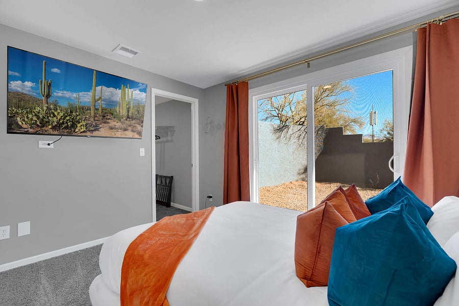 Sleep soundly in this stylish bedroom with a comfortable bed, calming tones, and a wall-mounted smart TV. A peaceful retreat where comfort meets entertainment.