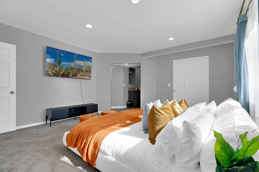 Enjoy restful nights in this minimalist bedroom featuring a comfy bed, clean design, and a flat-screen TV for cozy movie nights in. A relaxing space designed for your comfort.