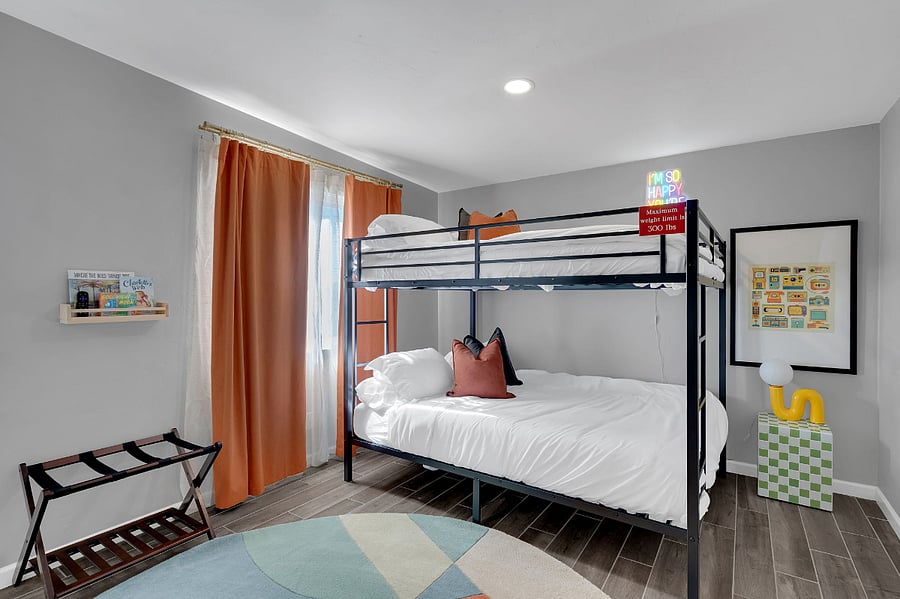 This inviting bunk bedroom offers cozy sleeping spaces, a flat-screen TV, and cheerful dcor. Ideal for families or groups, its a fun and comfortable space to rest and recharge.