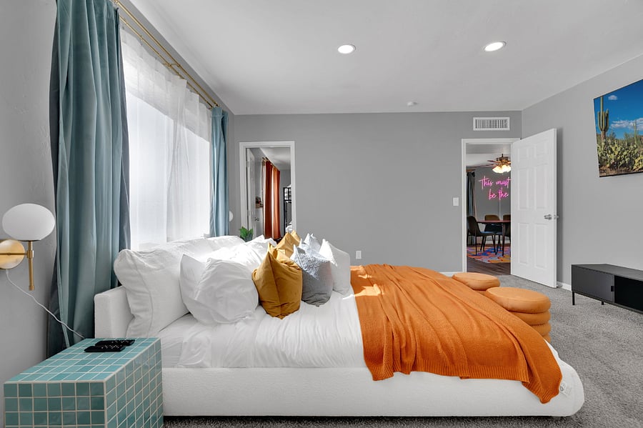 This inviting bedroom offers a comfortable bed for two, natural light, and a flat-screen TV. Perfect for guests seeking both relaxation and convenience during their stay.