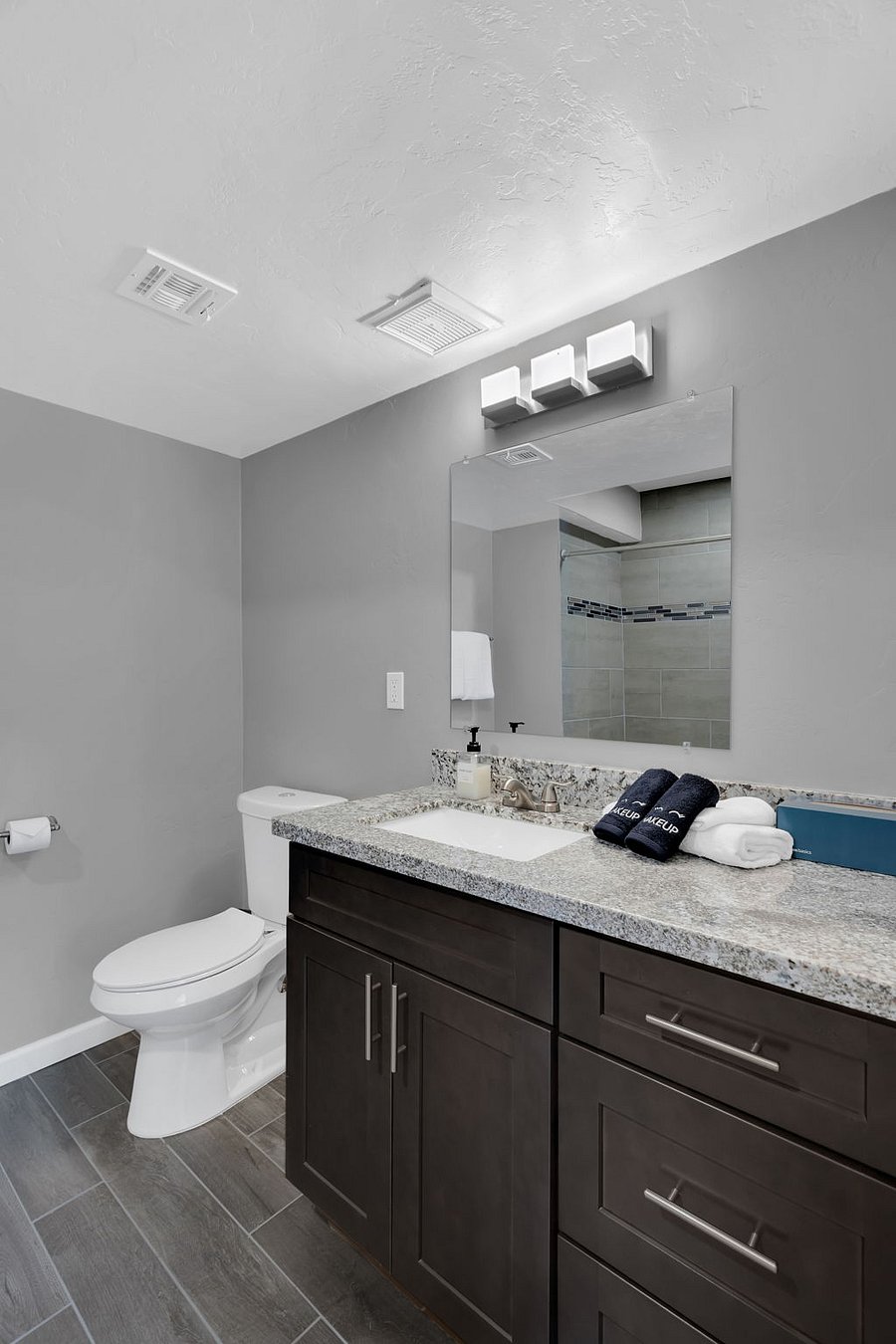 This spotless bathroom offers contemporary finishes, soft towels, and ample space to get ready for the day. A relaxing place to unwind with a warm shower.