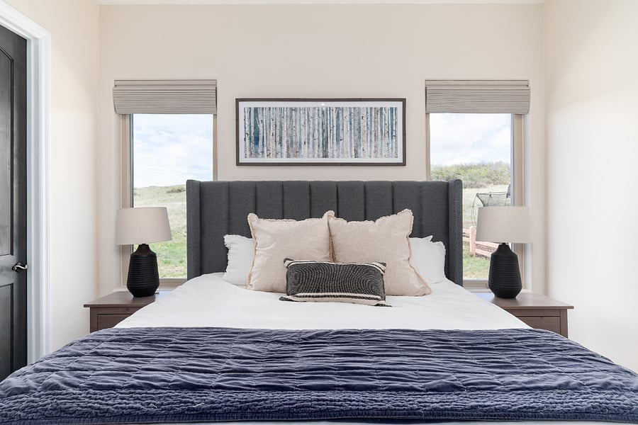 The bedroom is quiet and has open space behind it for privacy. The shades make the room very dark and are blackout curtains. 