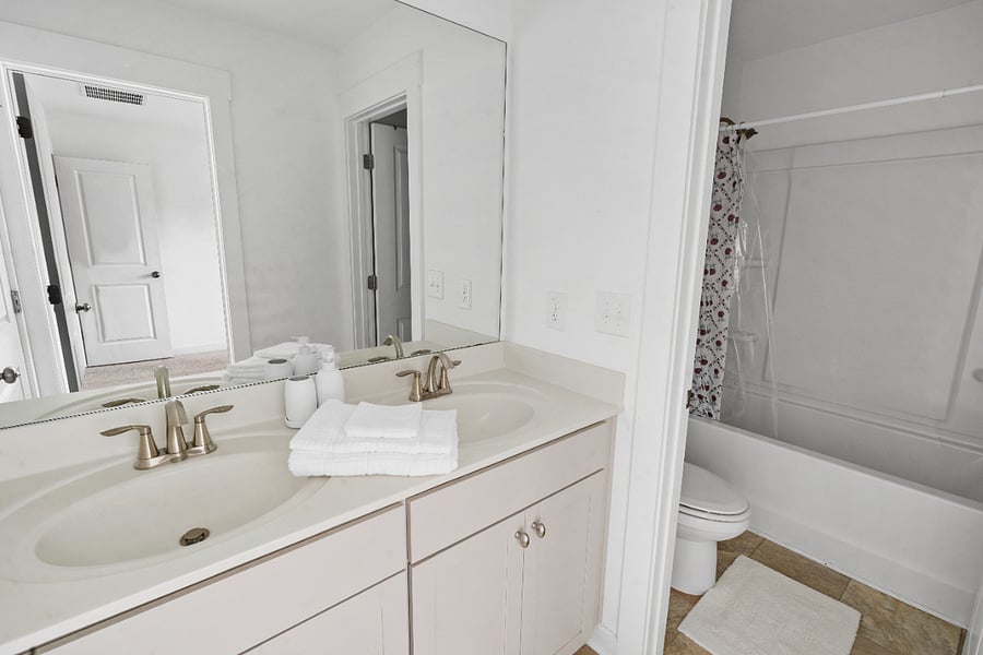 Double vanity bathroom with clean finishes and fresh towels.