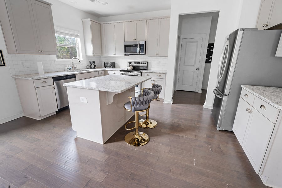 Modern kitchen with island seating and ample space.
