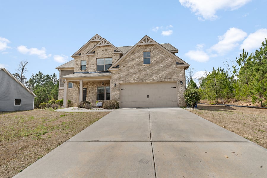 Large driveway and beautiful front exterior with great curb appeal.