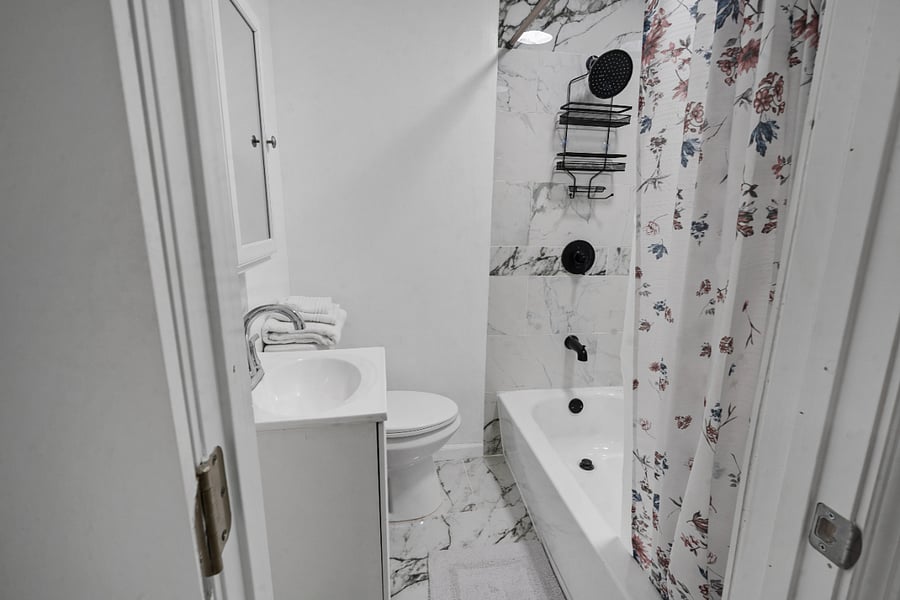 Clean bathroom with tub and shower combo.