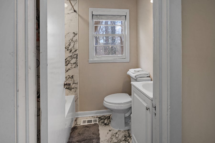 Clean bathroom with modern finishes and essentials.