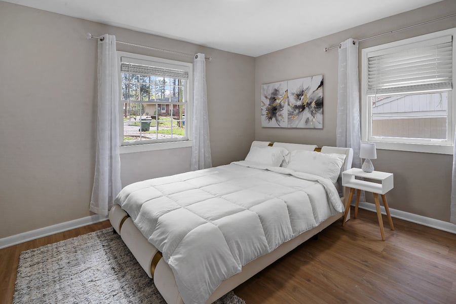 Bright bedroom with stylish dcor and cozy setup.
