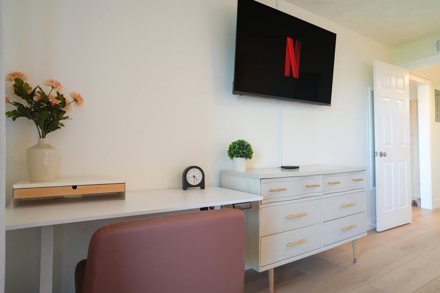 Adjustable standing desk in primary bedroom