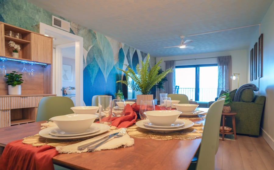 Dining area features 6 chairs and 2 bar stools