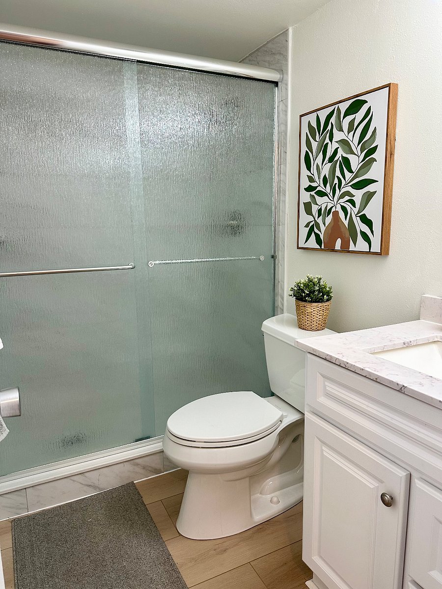 Bathroom 2 features a walk-in shower and a hair dryer.