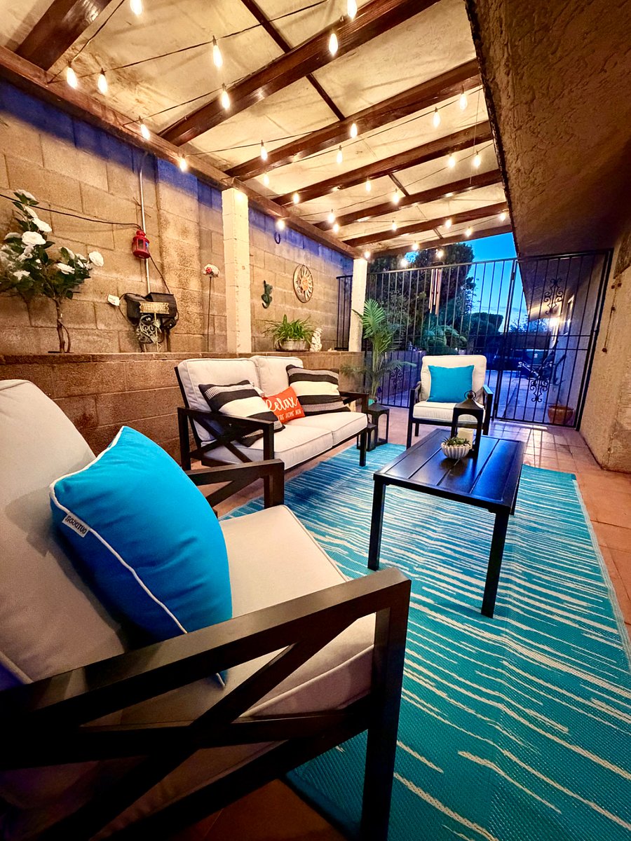 Covered patio with outdoor dining and relaxing backyard views.