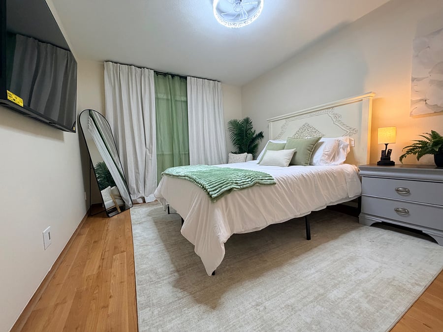Guest bedroom #2 with queen bed, blackout curtains, charging station, and ample storage and walk in closet. 
