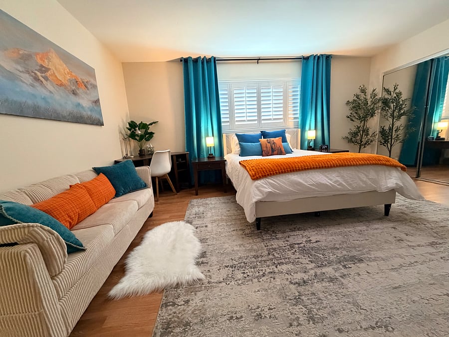 Primary bedroom

Primary suite with queen bed, dedicated workspace, blackout curtains, and private backyard access.