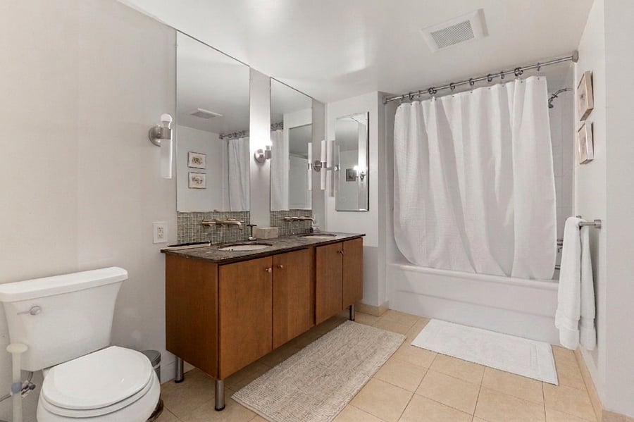 Refresh and recharge in this spa-like bathroom featuring a double vanity, granite countertops, and a full soaking tub for ultimate relaxation.
