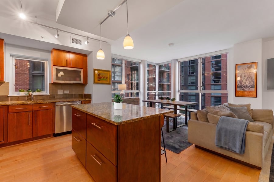 The open-concept layout seamlessly connects the chefs kitchen to the bright dining and living area.
